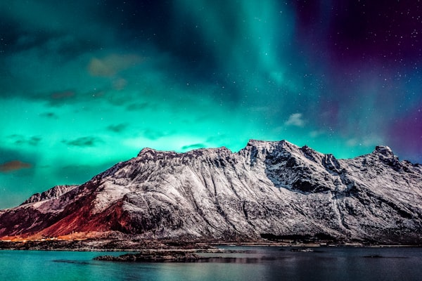 Aurora borealis over a misty mountain range