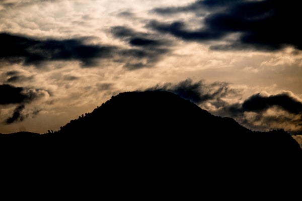 Dark mountain silhouette against a dramatic dusk sky